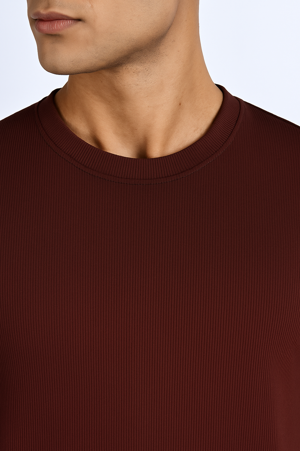 Close-up of a maroon ribbed ultra stretch T-shirt highlighting the ribbed texture and crew neckline.