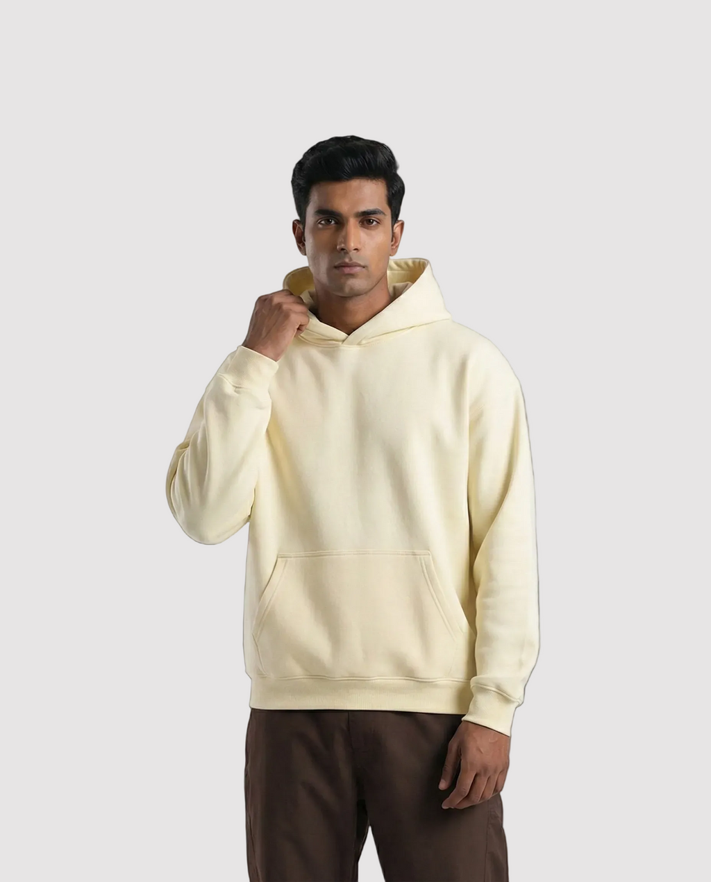 Man wearing a beige hoodie on a white background