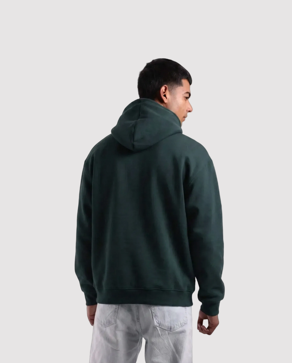 Person wearing a dark green hoodie from behind on a white background