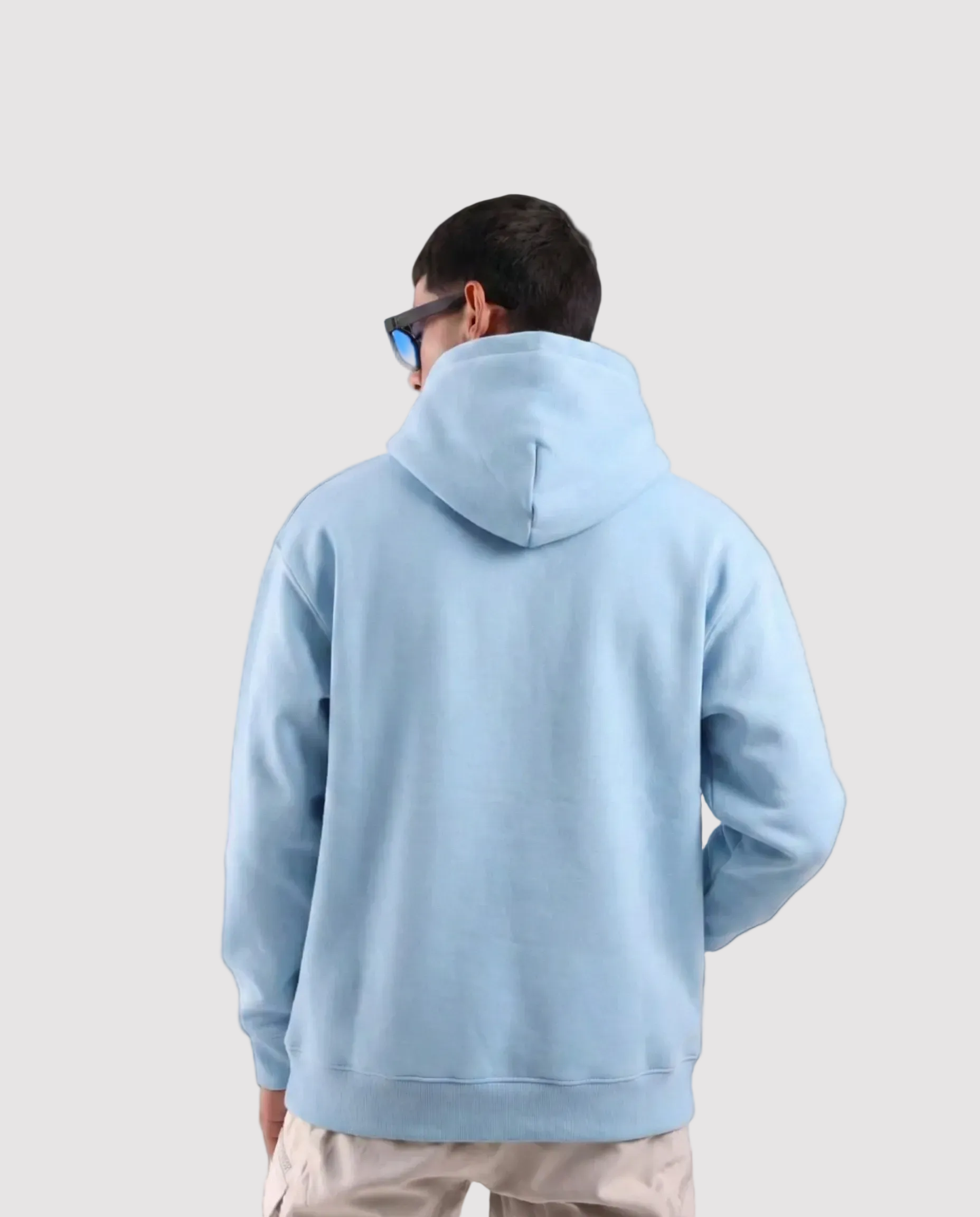 Person wearing a light blue hoodie from behind on a white background