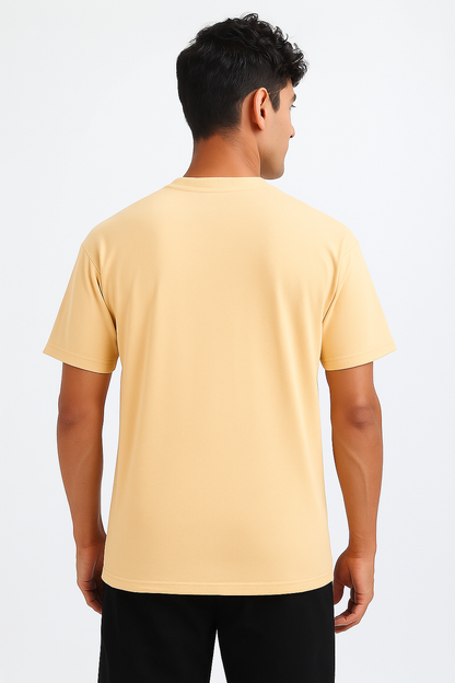 Back view of a Soft Ivory oversized t-shirt, laid flat, emphasizing its relaxed drape and seamless back design. Shows the wide-set shoulder seams typical of an oversized fit.