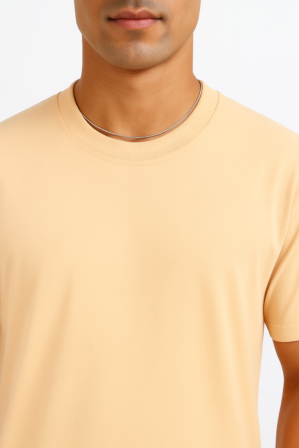 Close-up detail of a Soft Ivory oversized t-shirt, highlighting the premium cotton knit fabric texture, subtle ribbing on the collar, and fine stitching along the seams