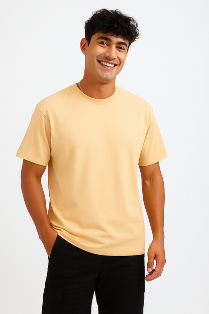 Front view of a Soft Ivory oversized t-shirt, laid flat, showcasing its relaxed fit, wide silhouette, and round neck. Highlights the clean, unprinted surface and soft fabric texture