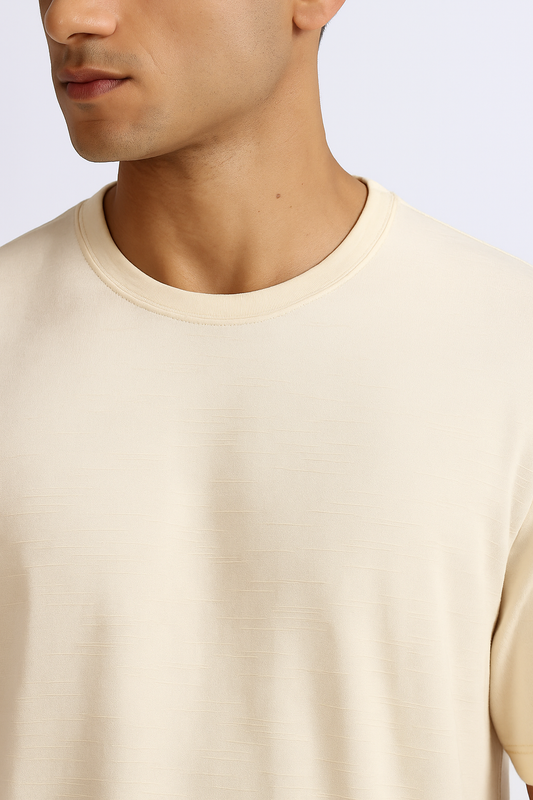 Close-up of beige ribbed ultra stretch T-shirt showing the detailed ribbed texture.