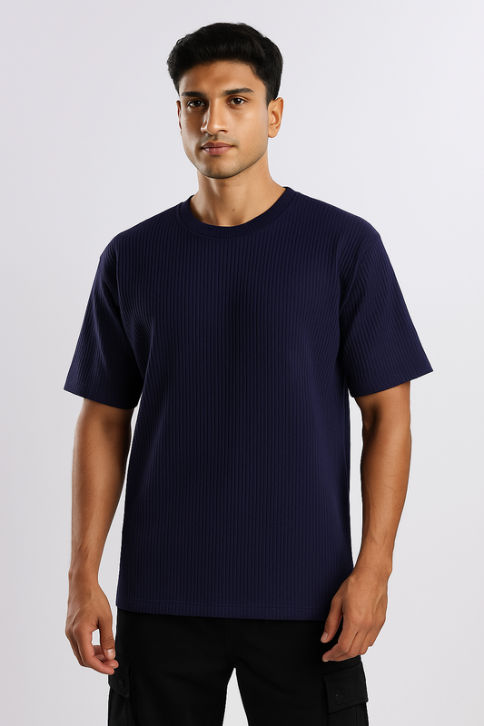 Man wearing a dark blue ribbed ultra stretch T-shirt, shown from the front.