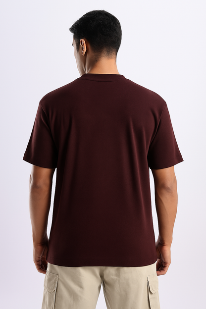 Man wearing a maroon ribbed ultra stretch T-shirt, shown from the back.