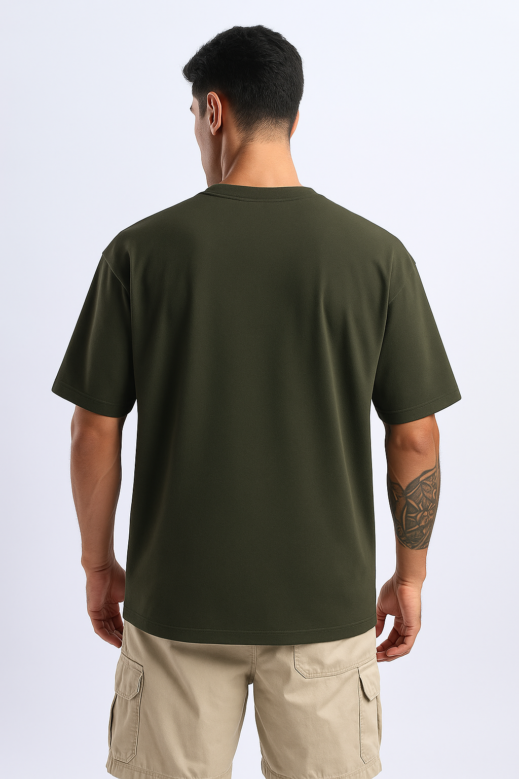 Rear shot of an olive oversized tee, emphasizing its flowy, comfortable fit from behind.