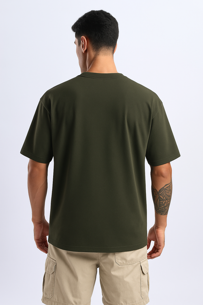 Rear shot of an olive oversized tee, emphasizing its flowy, comfortable fit from behind.