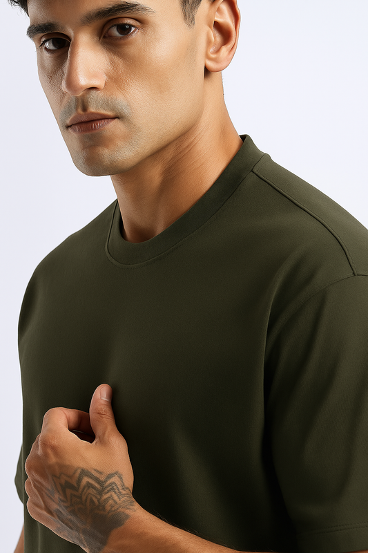 Close-up of the olive green fabric of an oversized t-shirt, showing the soft, breathable texture.