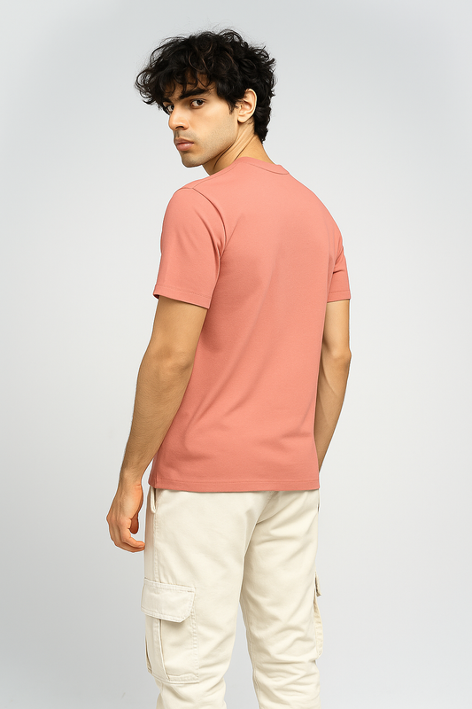 Man wearing a soft pink oversized T-shirt, shown from the back.